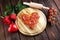 Valentines day pizza in heart shape on dark rustic wooden background