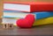 Valentines day red heart with colorful books on old wood. Holidays card.Valentines day. Heart pendant. Red heart. Valentine cards