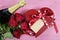 Valentines Day red heart shape gift box with bottle of champagne and red roses