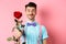Valentines day and romance concept. Funny guy with moustache giving red rose and smiling, making romantic gesture on