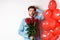 Valentines day romance. Worried boyfriend holding bouquet of red roses and red heart balloons, scratching head and