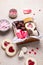 Valentines Day sweets and cookies in wooden box. Chocolate, candy, meringue, marshmallow, linzer cookies, gingerbread.