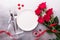 Valentines day table setting with bouquet of roses, red roses and champagne glasses on stone background. Top view. Valentine`s