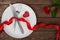 Valentines day table setting with plate, fork, knife, red heart, ring, ribbon and rose. background