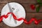 Valentines day table setting with plate, fork, knife, ring, ribbon and rose. background