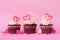 Valentines Day theme red velvet cupcakes with a pink background