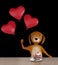 Valentines dog holding heart baloons -- isolated on black background. 3d render