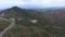 Valle De Cauca, Colombia. Mountain road with green forest on the background. Aerial top video. Car ride on the mountain road.