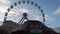 Valletta,Malta, 23.12.2023 - Spinning Ferris wheel, Rudolf\'s wheel in Fairyland, behind the toos the loop mini games