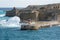VALLETTA, MALTA - DEC 31st, 2019: View from Fort St Elmo on to the Ricasoli Grand Harbour East Breakwater and red