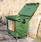 VALLETTA, MALTA - NOVEMBER 10TH 2019: A green rubbish bin stands open near the Valletta bus station. Ghalfejn thammeg pajjizek