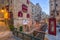 Valletta, Malta - Red vintage british telephone box and footbridge and traditional red balconies in the ancient city of Valletta