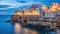 Valletta, Malta: skyline from Marsans Harbour at sunrise warm lights