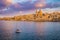 Valletta, Malta - St.Paul`s Cathedral in golden hour at Malta`s capital city Valletta with sailboat and beautiful colorful sky