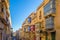 Valletta, Malta - Typical narrow street with colorful traditional windows