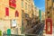 Valletta streetview with red balconies and phone booth - Malta