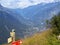 In the valley of the Alps you can see the inhabited locality. Pointers show directions for hiking trails