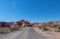 Valley of Fire - Panoramic view of endless winding empty Mouse tank road through canyons of red Aztec Sandstone Rock