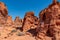 Valley of Fire - Woman at exterior entrance of windstone arch (fire cave) in Valley of Fire State Park, Mojave desert, Nevada, USA