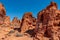 Valley of Fire - Woman at exterior entrance of windstone arch (fire cave) in Valley of Fire State Park, Mojave desert, Nevada, USA