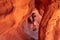 Valley of Fire - Woman standing in the fire cave and Windstone Arch in Valley of Fire State Park, Nevada, USA