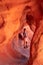 Valley of Fire - Woman standing in the fire cave and Windstone Arch in Valley of Fire State Park, Nevada, USA