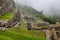 Valley with fog from a terrace at Machu Picchu ruins.