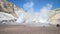 The valley of fumaroles with the eruption of water vapor and sulfur