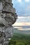 Valley and the lake. Large rock in the foreground at sunset