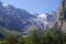 Valley in the mountains, overgrown with wood and glacier in the distance