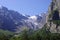 Valley in the mountains, overgrown with wood and glacier in the distance