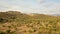 Valley with olive trees with high cliffs behind in Sierra Nevada mountains on a sunny day