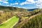 Valley with the river in the Czech Republic. Spring day in nature. View of the valley on the river. Wooded hills