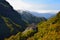 A valley with a rock and colorful trees near Rabacal, Madeira, Portugal