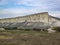 Valley with rural buildings on the background of the white cliffs of Mount Ak-Kaya in the Crimea.