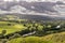 A valley with sheep and rain clouds