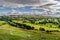 A valley with sheep and rain clouds