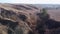 Valley with steep ravines with trees in autumn, aerial view