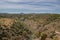 Valley with vegetation in aerial view and Oeiras river and gradient mountains in the horizon, Mértola PORTUGAL