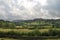 Valley wall slate tree branches mountain clouds