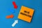 Value Proposition - concept of text on sticky note. Orange square sticky note and colorful arrows on blue background