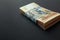 Value of Ukrainian hryvnia and American dollars. A pack of Ukrainian hryvnia wrapped one hundred dollar bill