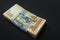 Value of Ukrainian hryvnia and American dollars. A pack of Ukrainian hryvnia wrapped one hundred dollar bill