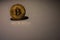 valueable golden bitcoin illuminated with shadow and reflection