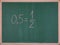Values in mathematics 0.5 = 1/2,written on the school board