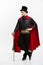 Vampire Halloween Concept - Full length Portrait of handsome caucasian Vampire in black and red halloween costume.