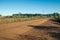 Van in a dirt road passing through rural lowlands