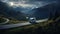 a van drives down a scenic rural road, surrounded by dramatic rocky mountains