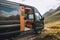 van with side door open, revealing the beautiful and rugged landscape