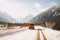 van, surrounded by snow and mountains, on scenic winter road trip